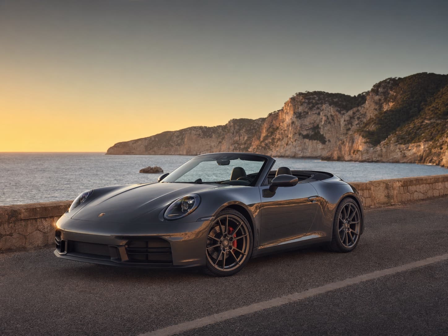 Porsche 911 Cabriolet-style GT convertible on an Ibiza coast road