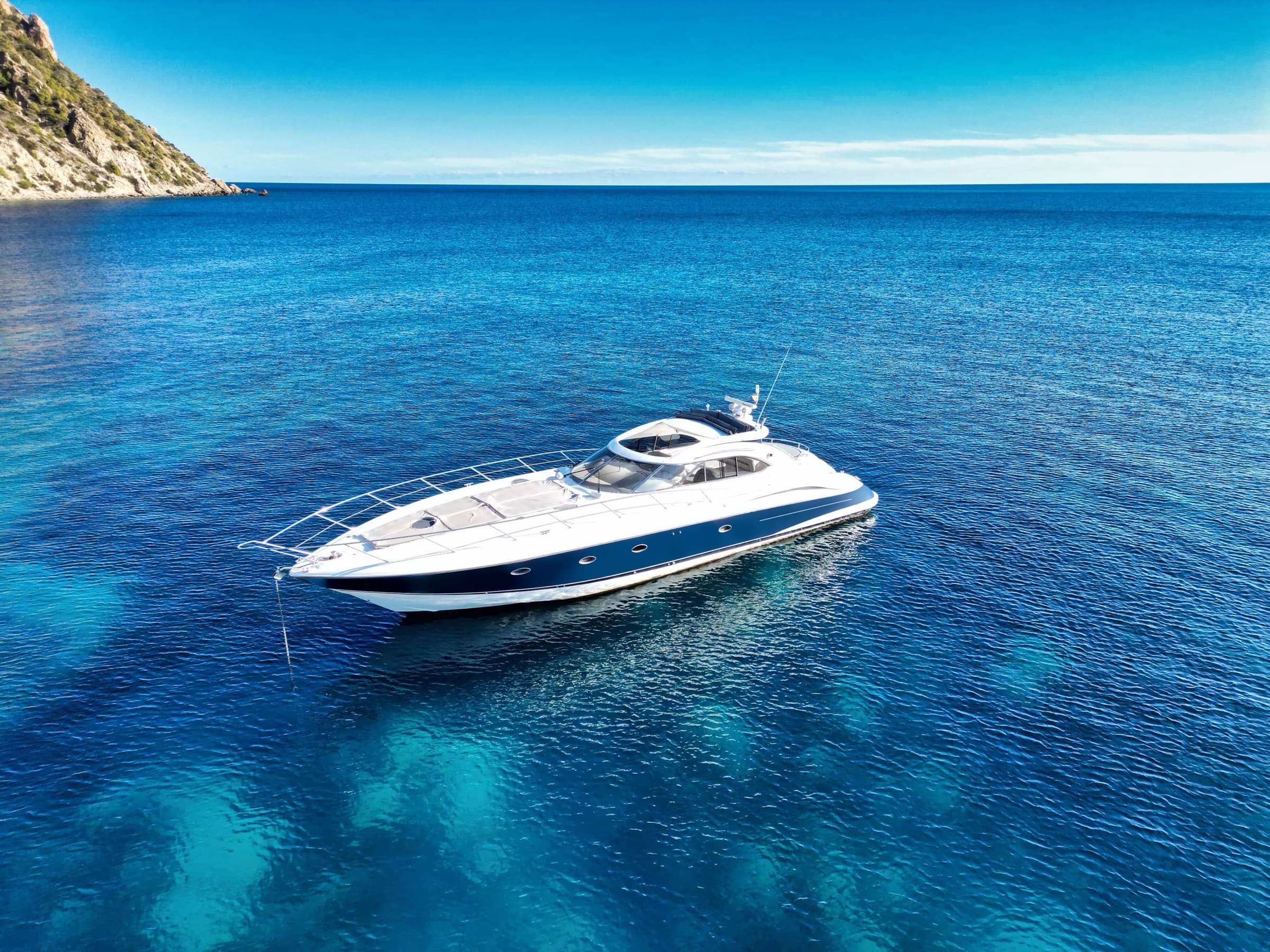 Yacht at anchor in turquoise water